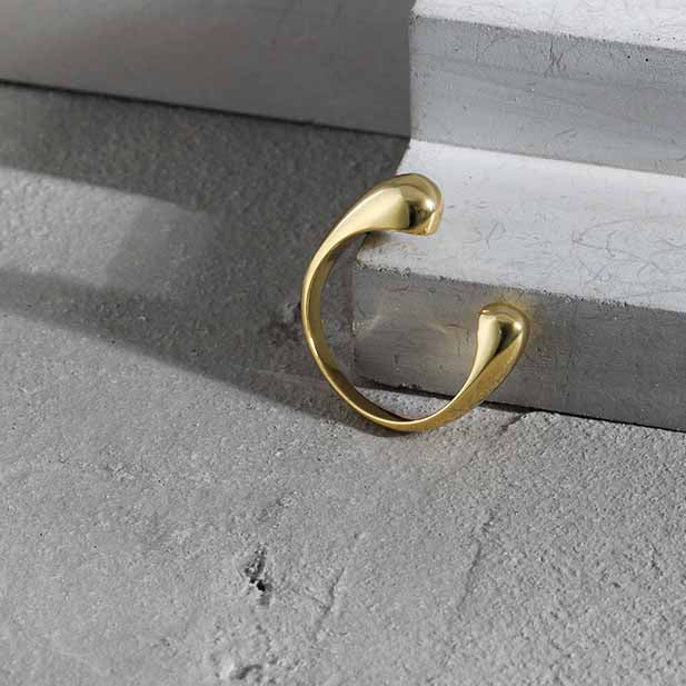 Twin Teardrop Open Ring in 925 sterling silver. Two rounded teardrop ends curve towards each other in an open band.
