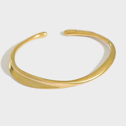 Twisted Curve Open Bangle in 925 sterling silver. A broad polished band turns into a fluid, sculptural twist.
