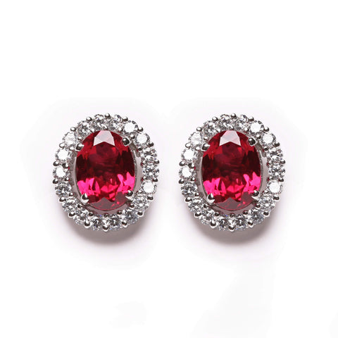 Ruby gemstone stud earrings with diamonds around the stone